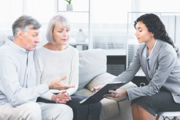 A lawyer advising an elderly couple about financial and legal planning.