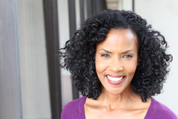 Attractive older Black woman smiling warmly