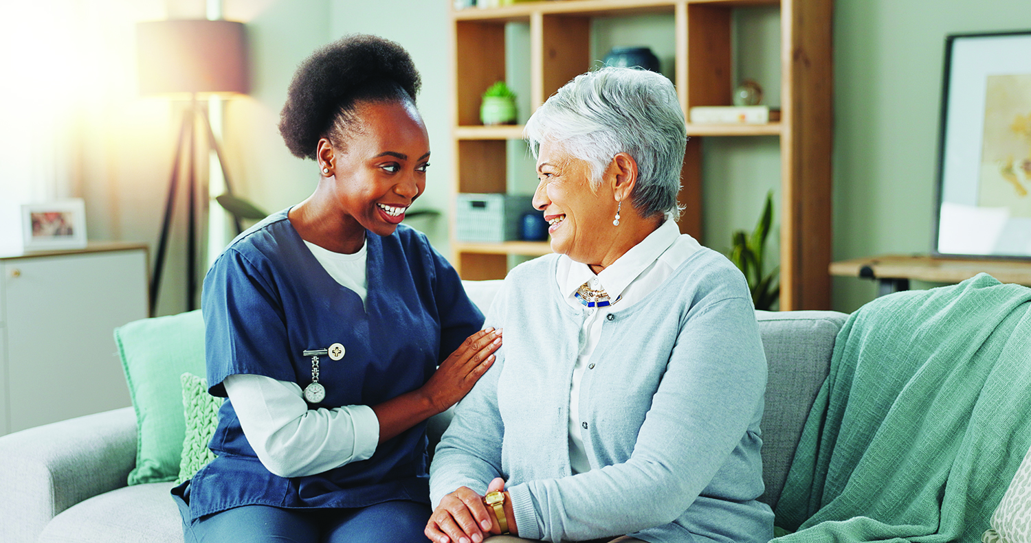Nurse comforting elderly woman at home, representing dementia care and support under Medicare’s GUIDE Model