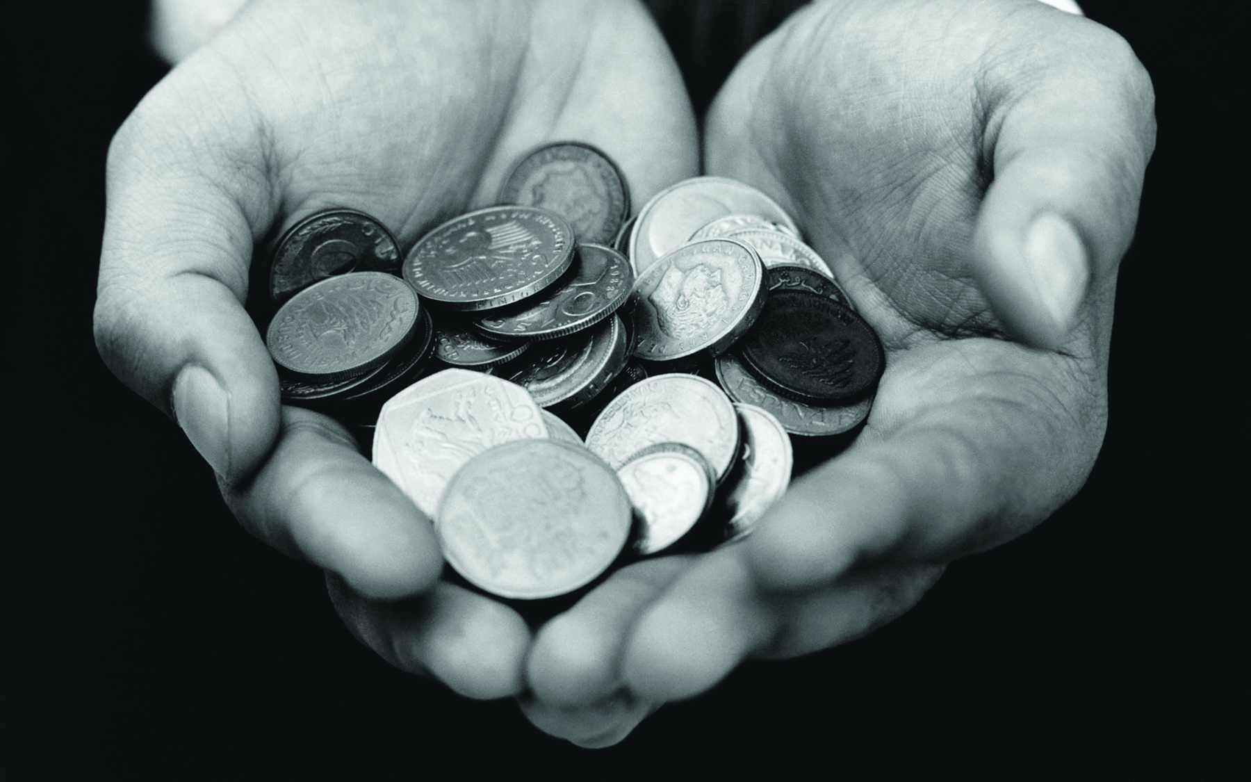 Man’s hands carefully holding collectible coins